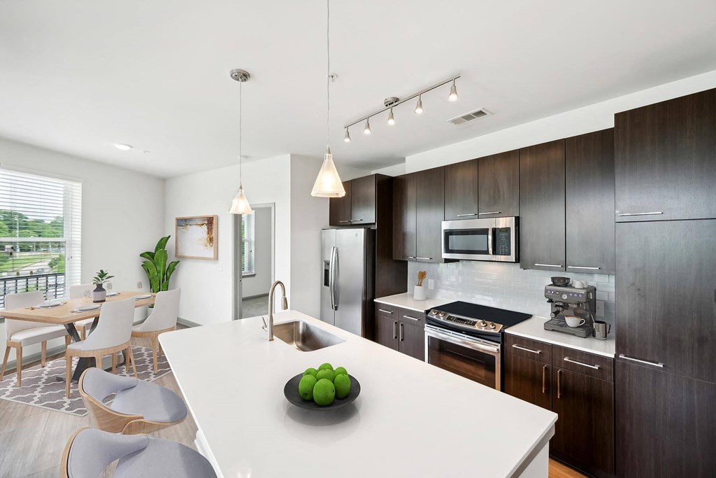 a kitchen with a white counter top a kitchen with a white counter top at Glenwood at Grant Park Apartments, Georgia, 30316